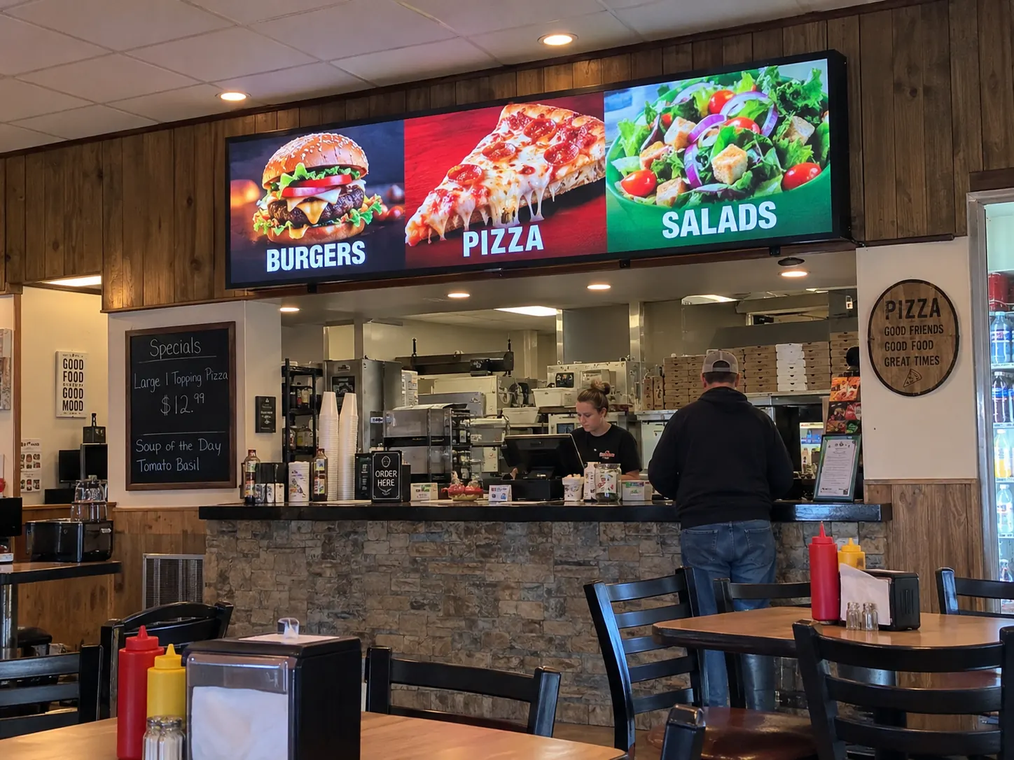 Wide indoor LED menu display above a restaurant service counter