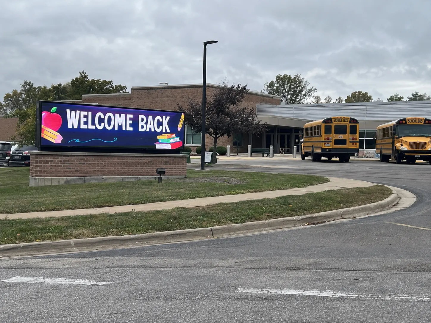 Outdoor LED message center in a school monument sign near the campus entrance